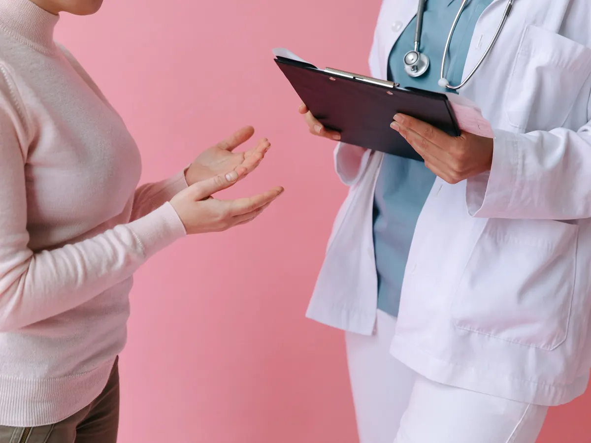 Médica conversando con una paciente en consulta
